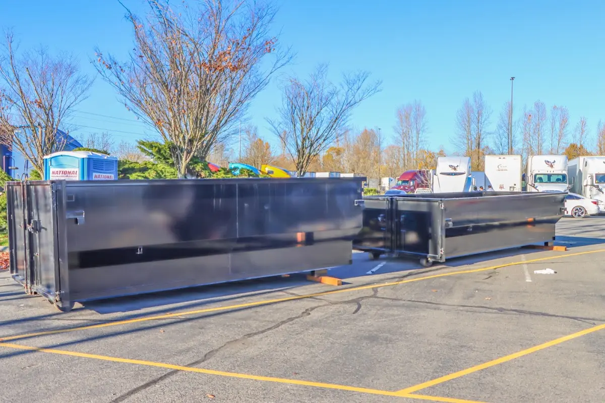 Professional dumpster rental service with roll-off container on residential driveway in Watchung